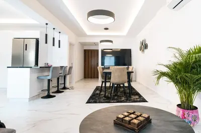 a kitchen and living room with a table and chairs at Kozakos Residence in Limassol