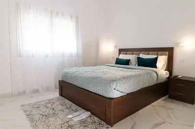 a bedroom with a large bed and a window at Kozakos Residence in Limassol