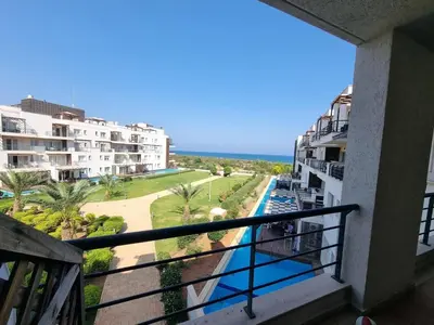 a balcony of a condo with a view of the ocean at North Cyprus Thalassa beach resort in Paralimni