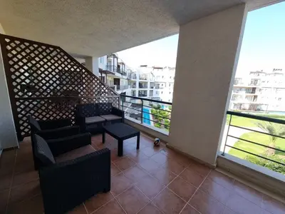 a balcony with chairs and tables in a building at North Cyprus Thalassa beach resort in Paralimni