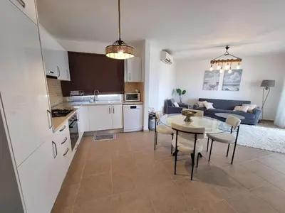 a kitchen and living room with a table and a couch at North Cyprus Thalassa beach resort in Paralimni