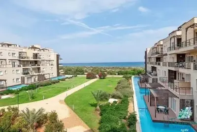an aerial view of two apartment buildings and a swimming pool at North Cyprus Thalassa beach resort in Paralimni