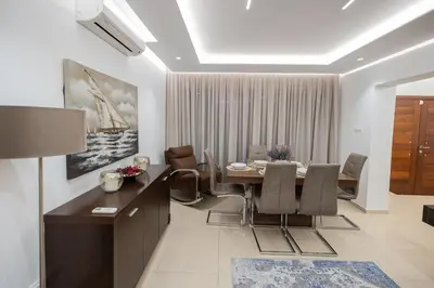 a dining room with a table and chairs at Lap of luxury in Limassol