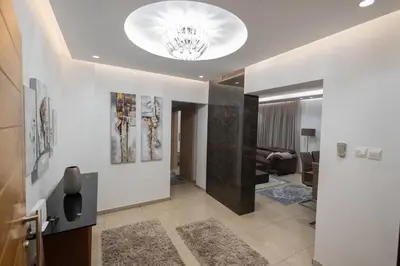 a living room with a chandelier on the ceiling at Lap of luxury in Limassol