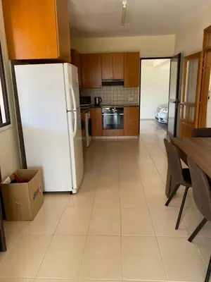 a kitchen with a white refrigerator and a table at A sea breeze villa in Pyla