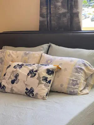 two pillows sitting on top of a bed at A sea breeze villa in Pyla