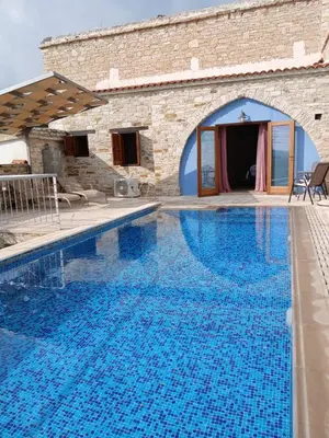 a large swimming pool in front of a building at Mountain View Oasis in Skarinou