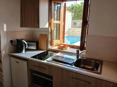 a kitchen counter with a sink and a window at Mountain View Oasis in Skarinou