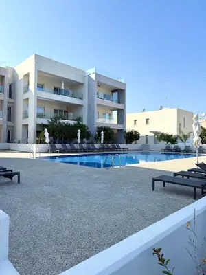 a view of a building with a swimming pool at Bella at Mythical Seas in Paralimni