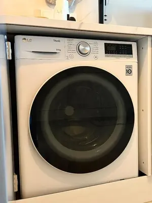 a white washing machine sitting in a kitchen at Bella at Mythical Seas in Paralimni