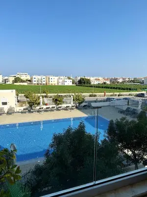 a view of a swimming pool from a building at Bella at Mythical Seas in Paralimni