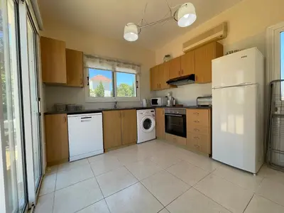 a kitchen with a white refrigerator and a dishwasher at Maeva villa in Ayia Napa