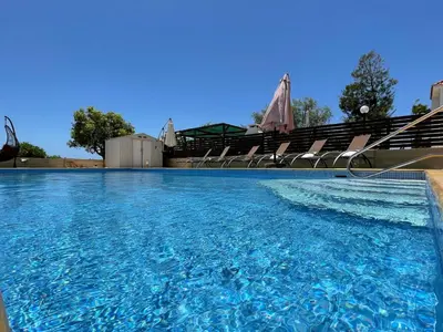 a swimming pool with empty seats in a stadium at Maeva villa in Ayia Napa