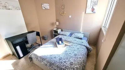 a small bedroom with a bed and a television at 5 Min Walk to Beach, Perfect Seaside Escape 3BR Shared Apartment in Larnaka