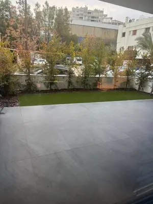 a concrete parking lot in front of a building at Nicosia Delux in Nicosia