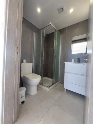 a bathroom with a toilet and a shower and a sink at Luxury 2 bedroom apartment 301 in Larnaka