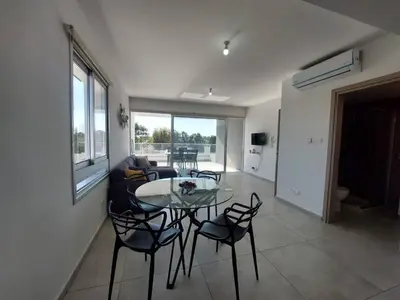 a living room with a glass table and chairs at Luxury 2 bedroom apartment 301 in Larnaka