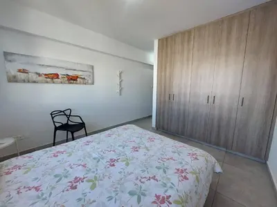 a bedroom with a bed and a wooden cabinet at Luxury 2 bedroom apartment 301 in Larnaka