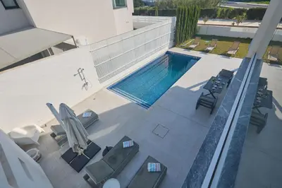 an overhead view of a swimming pool with patio furniture at Protaras Almaria Villa ALM03 in Protaras