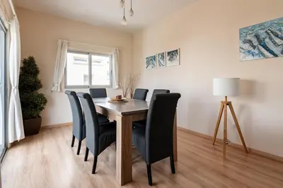 a dining room with a wooden table and chairs at Central, renovated, fully equipped, spacious 3BD in Strovolos