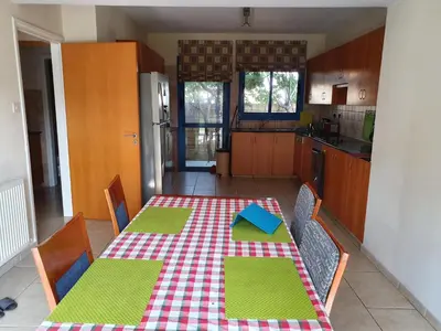 a kitchen with a table with a checkered table cloth at De Angelo Villa in Pyla
