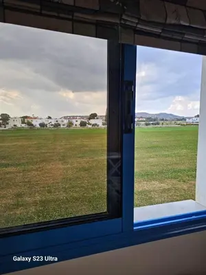 a window on a train looking out at a field at De Angelo Villa in Pyla