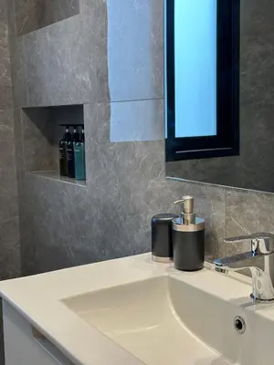a bathroom sink with a soap dispenser on it at Lux Hub Spot-Νear European Uni Engomi in Nicosia