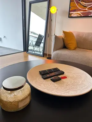a table with two remote controls on top of a table at Lux Hub Spot-Νear European Uni Engomi in Nicosia