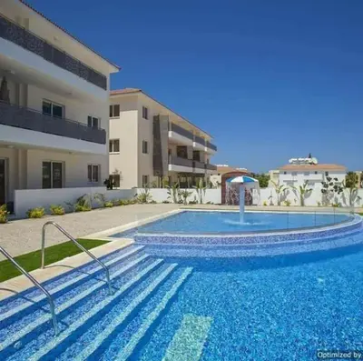 a large swimming pool in front of a building at Mythical Sands Resort - Africa in Protaras