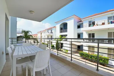 a balcony with a table and chairs and a view at Mythical Sands Resort - Africa in Protaras