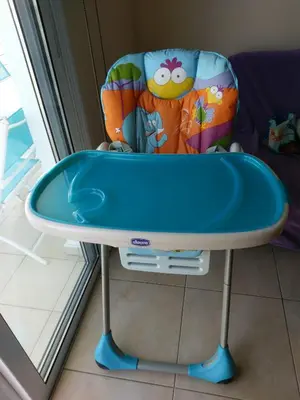 a blue table and a chair in a room at Mythical Sands Resort - Africa in Protaras