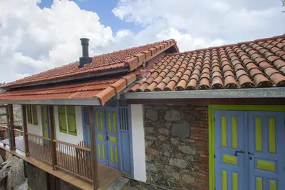 a house with blue doors and a red roof at Lyhnos in Askas