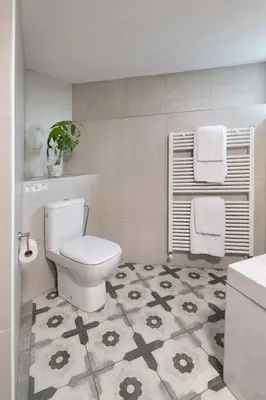 a bathroom with a toilet and a tile floor at Lyhnos in Askas