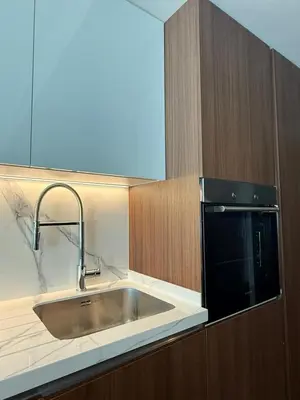 a kitchen with a stainless steel sink and a microwave at Grand sapphire resort Ötüken yeni iskele North Cyprus in İskele