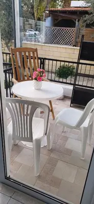 a white table and two chairs on a balcony at Magic Maisonette 250m from the beach in Larnaka