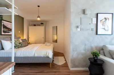 a bedroom with a bed and a couch at Luna - Homely Studio W Balcony in Larnaca in Larnaka