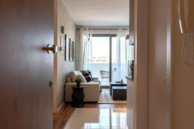 a hallway with a living room with a couch at Luna - Homely Studio W Balcony in Larnaca in Larnaka
