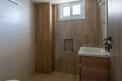 a bathroom with a sink and a shower with a window at Mosaic - 1 Bedroom Apartment in Larnaca in Larnaka
