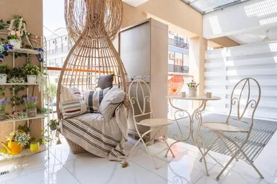 a person sitting in a chair in a room at Infinity - One-Bedroom Apt W Terrace in Larnaca in Larnaka