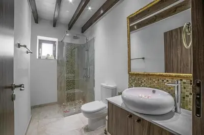 a bathroom with a sink and a toilet and a mirror at Sunrise Dream Villa-Protaras in Protaras