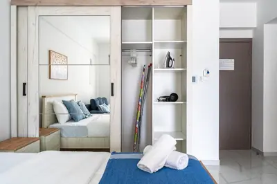 a bedroom with a bed with towels on the floor at Sunny Side Studio W Terrace in Larnaca in Larnaka