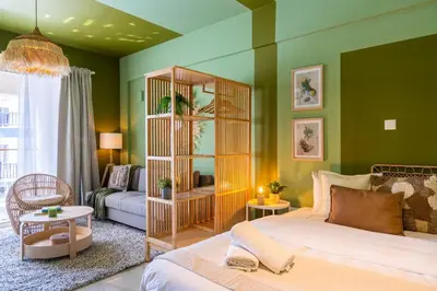 a bedroom with a bed and a living room at Sunstone - Cozy Studio W Terrace in Larnaca in Larnaka