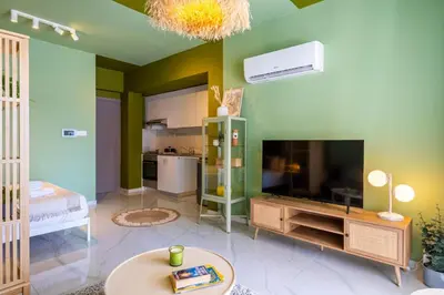 a living room with a large television and a table at Sunstone - Cozy Studio W Terrace in Larnaca in Larnaka