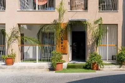 a building with potted plants in front of a door at Sunstone - Cozy Studio W Terrace in Larnaca in Larnaka