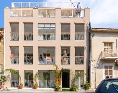 an apartment building with plants on the balconies at Sunstone - Cozy Studio W Terrace in Larnaca in Larnaka