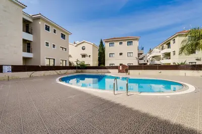 a swimming pool in front of some buildings at Apartment Sun 'n Joy in Paralimni