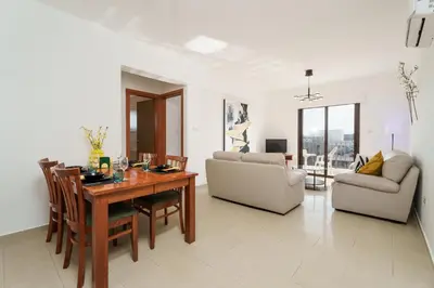 a living room with a dining table and a couch at Apartment Sun 'n Joy in Paralimni