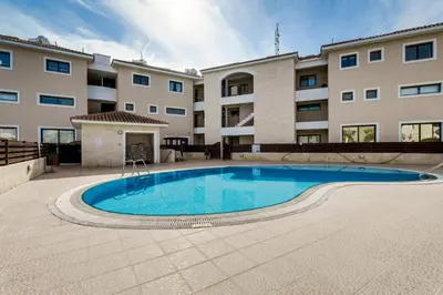a swimming pool in front of a building at Apartment Sun 'n Joy in Paralimni