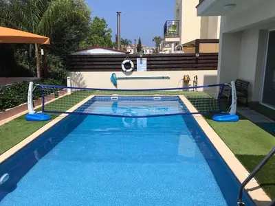 a swimming pool with a soccer ball in the middle at Sunshine Villa Private Pool Luxury Garden 2' walk to Kalamies beach Pernera in Protaras