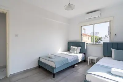 a bedroom with two beds and a window at Liric - 3 Bedroom Apt W Balcony in Larnaca in Larnaka